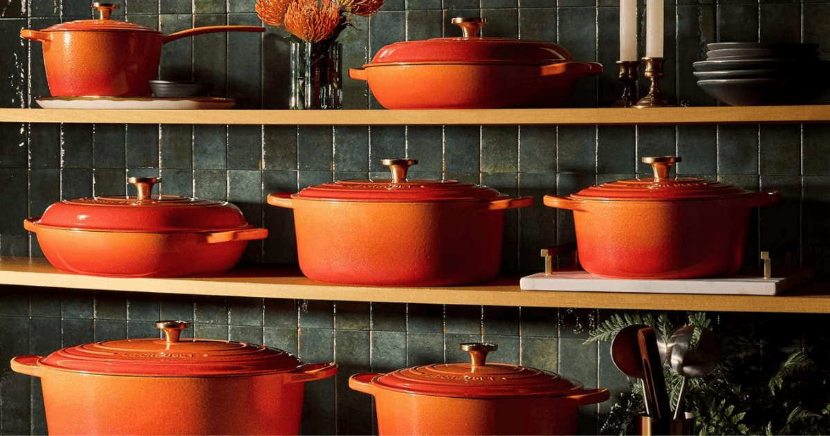 Varias piezas de Le Creuset Línea Centenario sobre tres estanterias